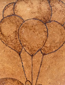 Close-up of woodburned balloons showing detailed pyrography texture.