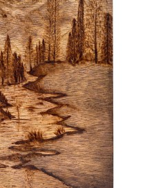 Intricate burnt shading of a river and shoreline in a pyrography nature scene.