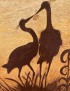 Close-up of pyrography detail showing the textured wood grain and charred bird silhouettes.