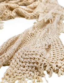 Close-up of the intricate mesh and floral lace texture of the yellow silk scarf.