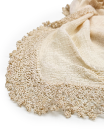 Close-up of weaved silk fabric texture and handmade crochet border.