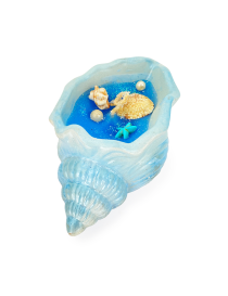 Blue concrete seashell candle with starfish and pearl decorations.
