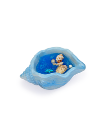 Top view of blue shell candle showing glitter and sea-themed embeds.