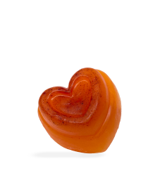 Three-quarter view of a heart-shaped orange turmeric glycerin soap bar.