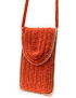 Close-up of the textured crochet stitch pattern in burnt orange.