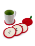 Red crochet apple coaster under a white mug with apple slice coasters lined up.