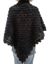 Rear view of a woman wearing a black triangular crochet wrap.