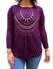 Front view of woman wearing a purple handmade crochet cotton sweater with sunburst pattern.