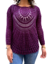 Front view of woman wearing a purple handmade crochet cotton sweater with sunburst pattern.