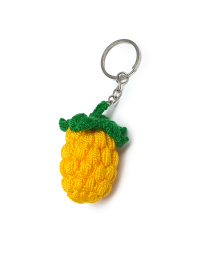 Yellow handmade crochet pineapple keychain with green leaves on a silver ring.
