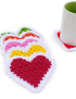 Close-up of multi-colored crochet heart coasters showing red, yellow, and pink centers.