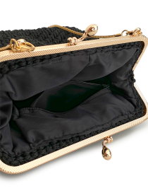 Open black macramé bag showing interior lining and zipper pocket.