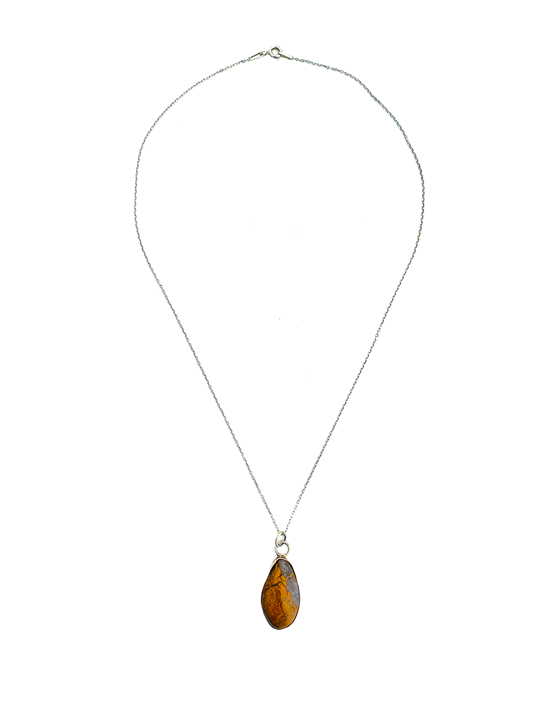 Natural Tiger's Eye teardrop pendant in silver setting.