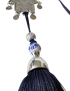 Close-up of a blue and white floral ceramic bead and silver tassel cap.