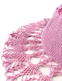 Detailed shot of intricate crochet stitching on a pink cotton hat.
