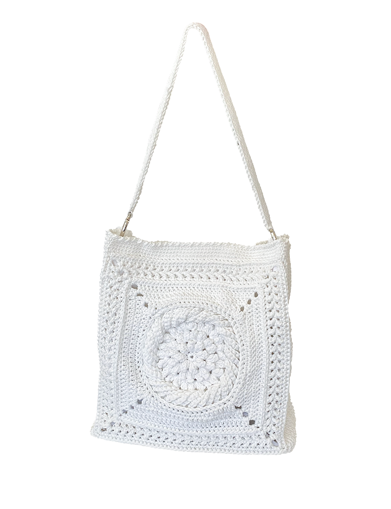Front view of large white crochet tote bag with central sunburst pattern.