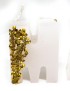 White wax letter candles with gold glitter accents spelling out a word on a white surface.