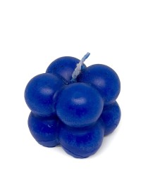 Deep blue bubble cube candle with cotton wick on a white background.