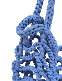 Blue crochet net market bag filled with oranges on a white background.