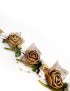 Golden fabric rose wreath accessory with white berries on a gold ribbon.
