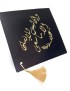 Graduation cap topper with gold Arabic calligraphy and colorful floral embroidery.