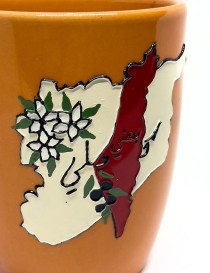 Orange handcrafted ceramic mug featuring a 3D map of Syria and white jasmine flowers.