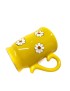Hand-painted yellow ceramic mug with white daisy floral design and decorative handle.