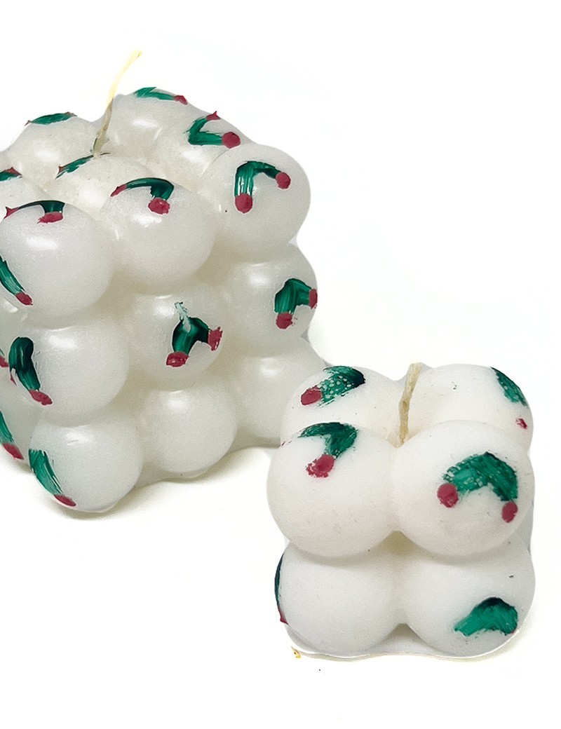 White bubble cube candle with hand-painted green holly leaves and red berries.