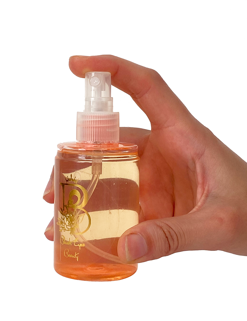 Hand spraying Black Eyes Beauty hypoallergenic mist
