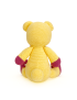 Back view of a yellow crochet teddy bear showing a small rounded tail.