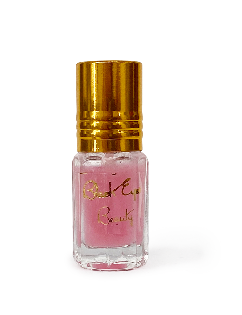 Handmade Pomegranate Musk fragrance oil in a glass bottle with a decorative gold cap.