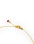 lose-up of gold lobster clasp and red bead charm extension on necklace.