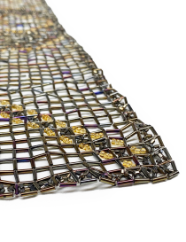 Macro view of geometric bead weave and heart pattern.