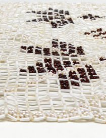 Detailed angled view showing the texture and shine of the cream glass beads.