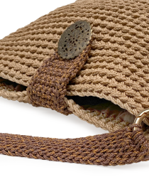 Detailed view of the antique bronze filigree medallion clasp.