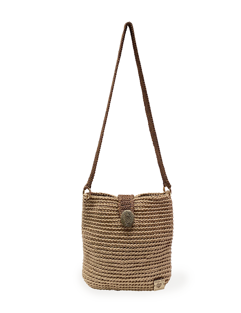 Front view of a tan handmade crochet crossbody bag.
