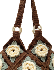 Detailed view of crochet shoulder straps attached with cream-colored rings.