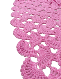Scalloped edge detail of handmade pink crochet scarf.