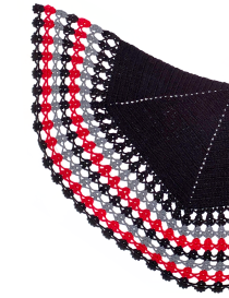 Close-up of intricate crochet lace stitching in red, grey, and black yarn.
