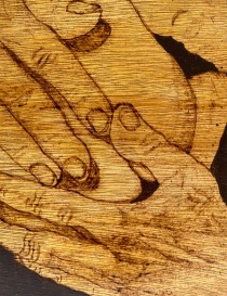 Detailed wood grain and hand-etched linework of pyrography art.