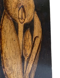 Macro shot of the intricate line work and shading on the woodburned Calla Lily petals.