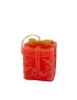 Side view of handmade red Christmas present candle.