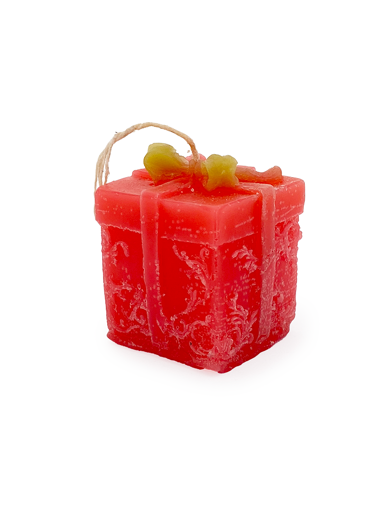 Red gift box shaped candle with gold bow and floral pattern.