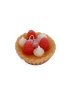 Side angle of a decorative berry cupcake candle on white background.