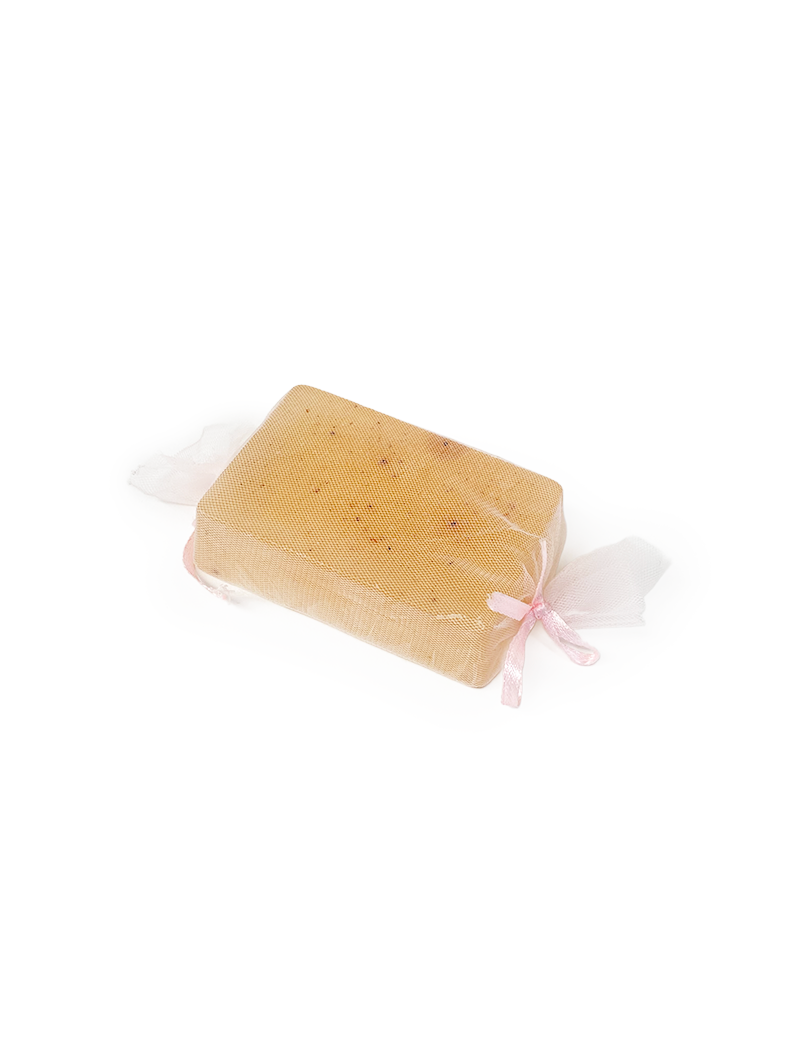 Rectangular Frankincense glycerin soap bar in white mesh wrap with pink ribbon.