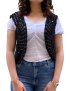 Front view of a model wearing a black handmade crochet vest with blue jeans.