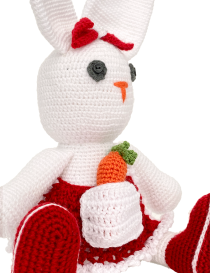 Detailed view of crochet stitching on the bunny face and red bow.