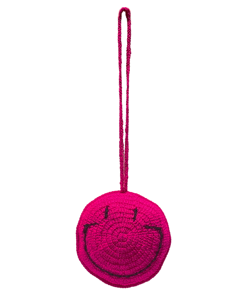 Handmade fuchsia pink crochet smiley face hanging decoration.