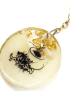 Detailed view of artistic Arabic script and shimmering gold flakes embedded in clear resin.