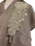 Front view of the shawl's artisanal metallic accents against the taupe cashmere background.